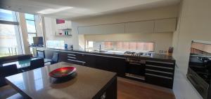 a large kitchen with a table and a counter top at Lakeshore Springs Apartments in Wanaka