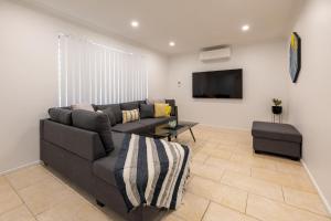 een woonkamer met een bank en een tv bij 5 Swan Valley Special 3br 15 Bth - SUPERHOG VERIFICATION REQUIRED in Perth