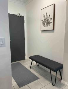 a black bench in a room with a black door at 1BR Condo DWTN Toronto - free Parking, Gym & Pool in Toronto