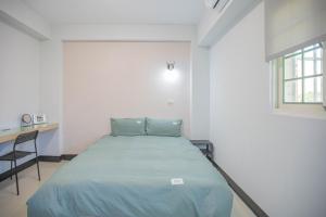 Postel nebo postele na pokoji v ubytování 卡薩行旅貳館 包棟民宿