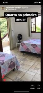 a picture of a room with two beds in it at Casa de Japaratinga in Japaratinga