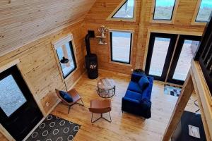 an overhead view of a living room in a cabin at Islander Lodge - Lochaber Lake Lodges in Antigonish