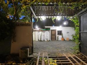 an entrance to a garage at night with lights at La cabaña M in Pereira