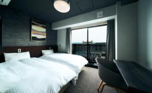 a hotel room with two beds and a window at Rakuten STAY Kyoto Station in Kyoto +43 photos