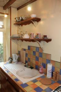 a bathroom with a sink and a tiled counter at Chez Christophe in Lille