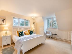 a bedroom with a white bed and two windows at Twegan in Trunch