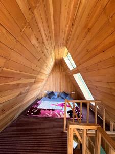 a large wooden room with a bed in it at Pinehill cottage in Jibhi +8 photos