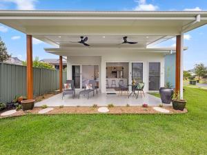 a covered patio with a table and chairs at Little Kim Close in Woolgoolga