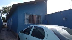 une voiture blanche garée devant un bâtiment bleu dans l'établissement Casa de Praia com Piscina em Mongagua - Disponivel Carnaval, à Mongaguá