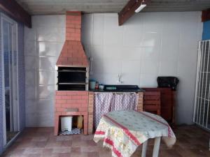 una cocina de juguete con horno de ladrillo en una habitación en Casa de Praia com Piscina em Mongagua - Disponivel Carnaval en Mongaguá