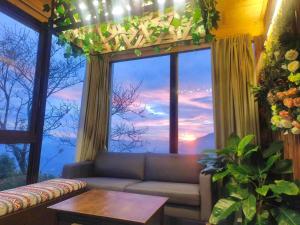 a living room with a couch and a large window at Villa Relax in Renai
