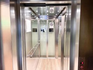 an elevator in a building with a wooden floor at City Hotel West in Frankfurt