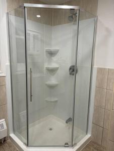 a shower with a glass enclosure in a bathroom at Cozy Spacious Work Friendly Lotus with Garden View High speed free Wi Fi and Parking Adjacent to Downtown Montreal in Montreal