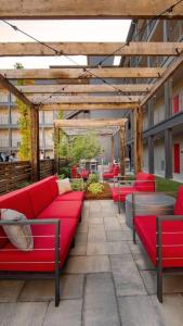 a group of red couches sitting on a patio at Optimum - Groovy Sanctuary! in Birmingham