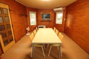 a conference room with a table and chairs and a television at Cottage All Resort Service / Vacation STAY 8371 in Inawashiro