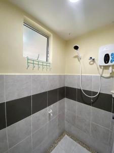 a bathroom with a shower with a window at BARAKAH HOMESTAY in Kota Tinggi