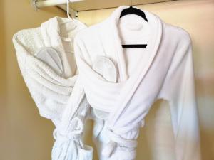 a group of white sweaters hanging on a rack at White Sands Casita in Alamogordo