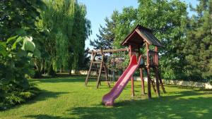 a playground with a slide and a play house at Vila Zorii Zilei in Baile Felix +8 photos