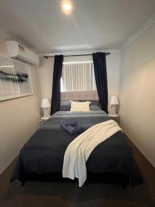 een slaapkamer met een groot bed en een raam bij 63a Joondalup Jewel Sleeps 2 1br1bth- SUPERHOG VERIFICATION REQUIRED in Perth