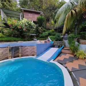 una piscina en un patio con una casa en D'Bukit Forest en Pedas