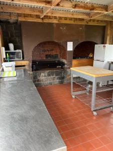 a kitchen with a brick oven with a table at The Ranch Mornington Peninsula in Boneo