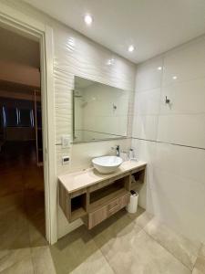 a bathroom with a sink and a mirror at Playa Grande Apartment in Mar del Plata