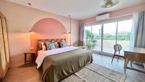 a bedroom with a bed and a large window at The STYLISH Hometel Sukhumvit in Bangkok +60 photos