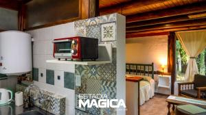 a kitchen with a microwave on a wall at Cabañas en Malargue in Malargüe +35 photos