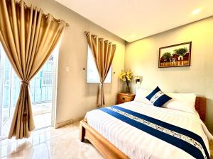 a bedroom with a bed and a window at LUAN VU Hotel - Bui Vien Walking Street in Ho Chi Minh City