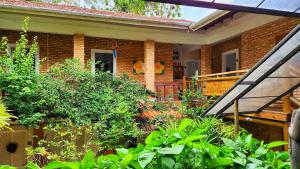 a house with a garden in front of it at Pousada Lacosta in Ilhabela