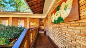 a hallway of a house with a brick wall at Pousada Lacosta in Ilhabela