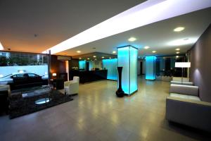 a living room with a couch and a room with blue lights at Hotel Africa in Maputo +21 photos