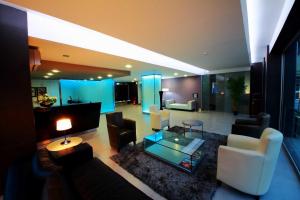 a living room with a couch and chairs and a table at Hotel Africa in Maputo