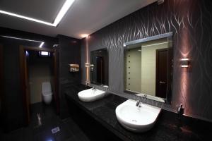 a bathroom with two sinks and two mirrors at Hotel Africa in Maputo