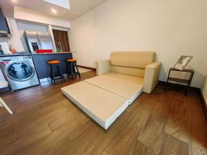 ein Wohnzimmer mit einem Sofa und einer Waschmaschine in der Unterkunft 706 Torres Los Yoses Hermoso apartamento en Barrio Escalante con Parqueo in San José