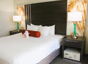 a hotel room with a large bed with two lamps at Elevated Aqua Palms Waikiki Studio condo in Honolulu