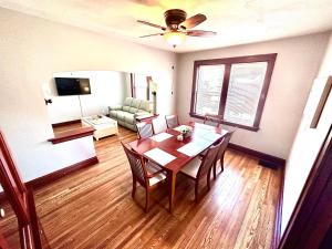 a living room with a dining room table and a couch at New 3 Bedroom City Escape in Saint Louis