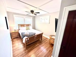 a bedroom with a bed and a ceiling fan at New 3 Bedroom City Escape in Saint Louis