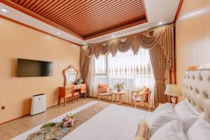 una camera d'albergo con letto, tavolo e sedie di Tuan Nam Hotel a Hai Phong