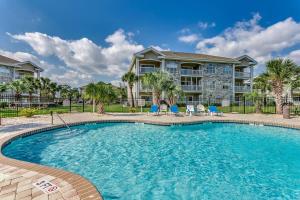 a swimming pool in front of a large building at Luxury 2 Bedroom priced like a hotel., pets ok in Myrtle Beach