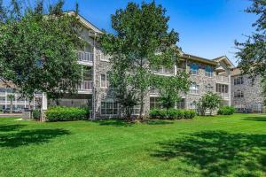 an apartment building with a lawn in front of it at Luxury 2 Bedroom priced like a hotel., pets ok in Myrtle Beach