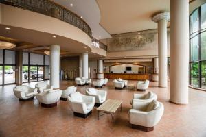 a lobby with couches and chairs in a building at Nouvata in Noumea