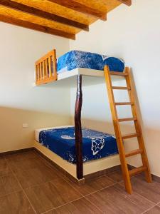 two bunk beds in a room with a ladder at Hotel Gran Azul Bungalows in Canoas De Punta Sal