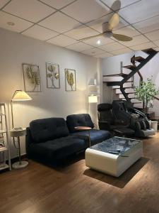 a living room with a couch and a table at Gachilly House - Your Cozy Home In The Heart Of The BMT City in Buon Ma Thuot +17 photos