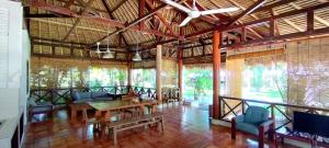 a dining room with a table and chairs in a building at Amrita Maumere Resort in Maumere