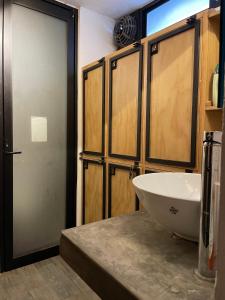 a bathroom with a white sink and a door at Hostal La Isla in San Crist&oacute;bal de Las Casas