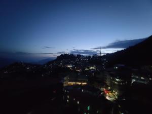 a view of a city at night at Keswani Group Tashi Heritage Hotel & Resort in Gangtok