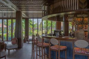 a bar in a restaurant with chairs and tables at Mandala Retreats Kim Bôi in Hòa Bình