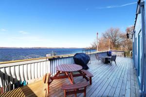 a wooden deck with a table and chairs on it at Chain O' Lakes Beach Penthouse with Lake Access in Ingleside