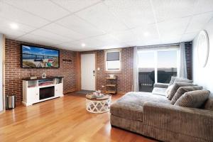 a living room with a couch and a tv at Chain O' Lakes Beach Penthouse with Lake Access in Ingleside